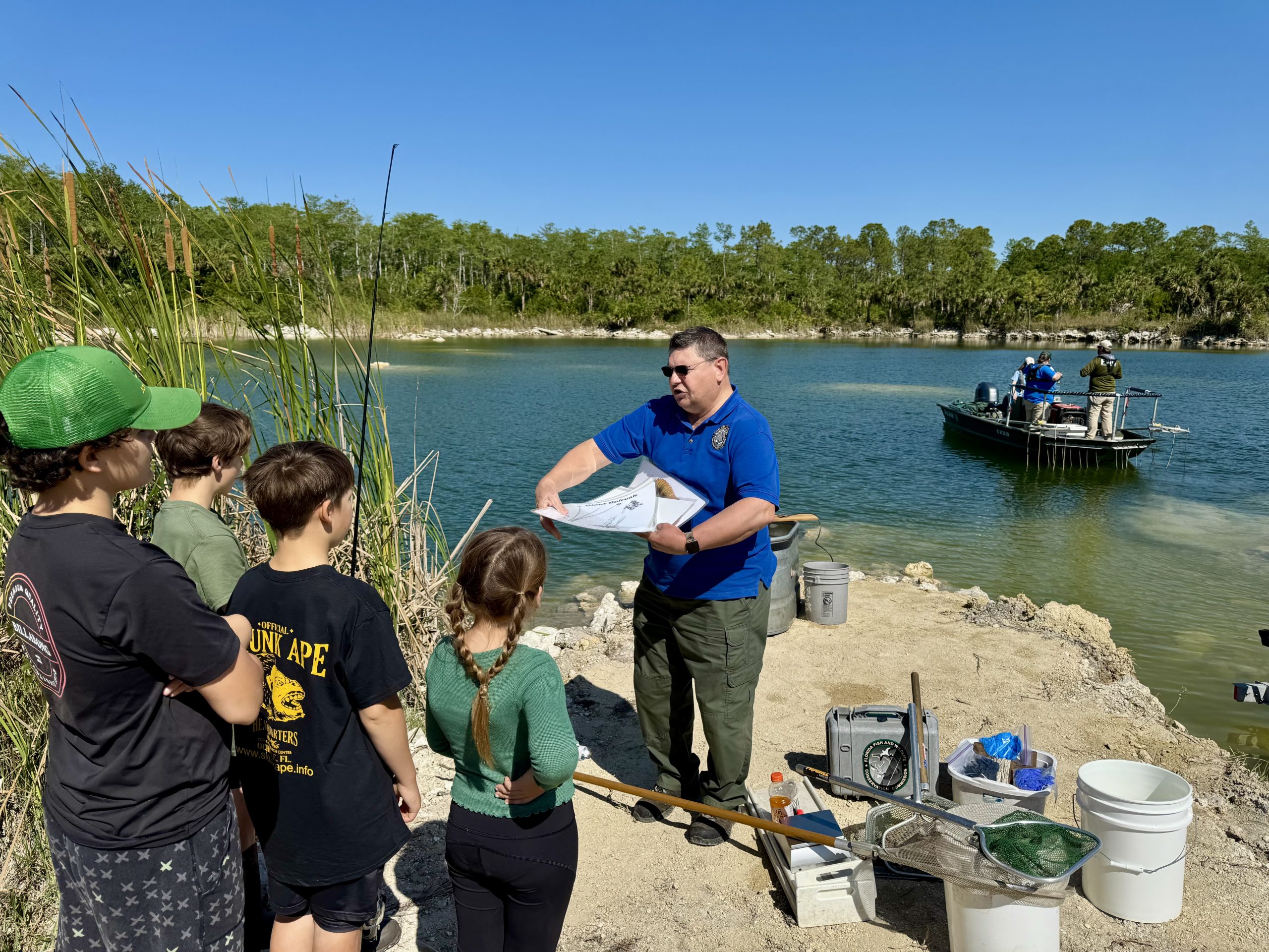 image of John Cabrera from FWC showing group about habitat fish and littoral plants